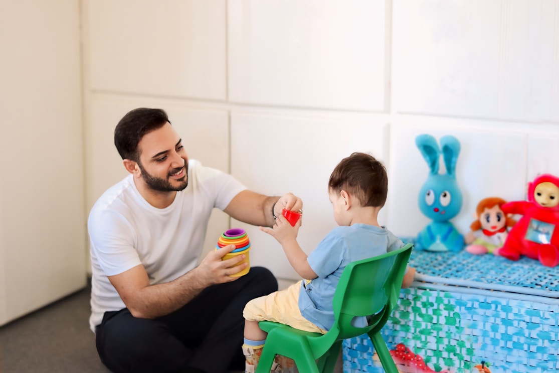 A doctor listening to a young girl's back with a stethoscope