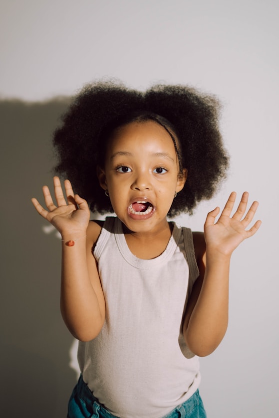 A girl with her hands raised, mid-expression