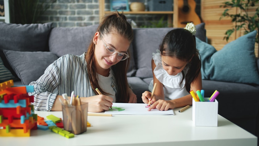A mother and daughter colouring together at a table