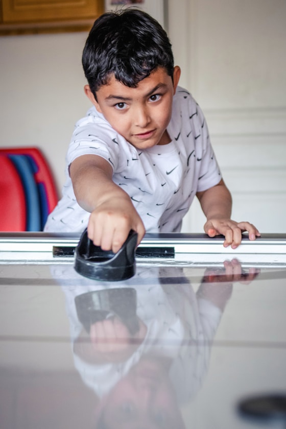 A boy playing air hockey