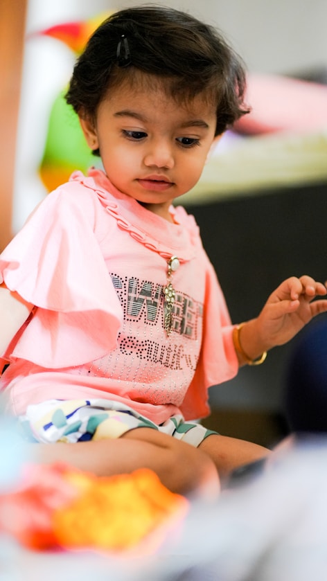 A girl playing with blocks in a colourful room
