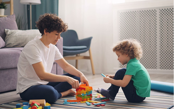 A parent and child playing with blocks during occupational therapy at Hiba