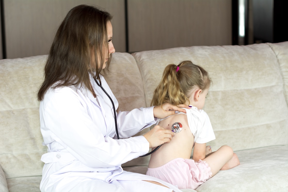 A doctor examining a young child with a stethoscope